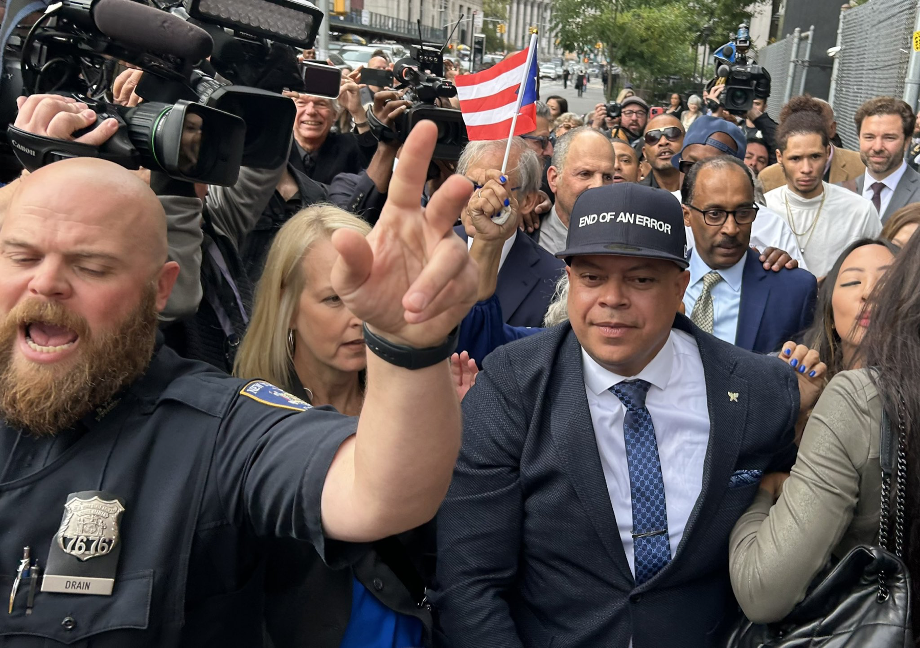 JJ Velazquez wearing an END OF AN ERROR hat amid the crowd outside court on the day his conviction was vacated
